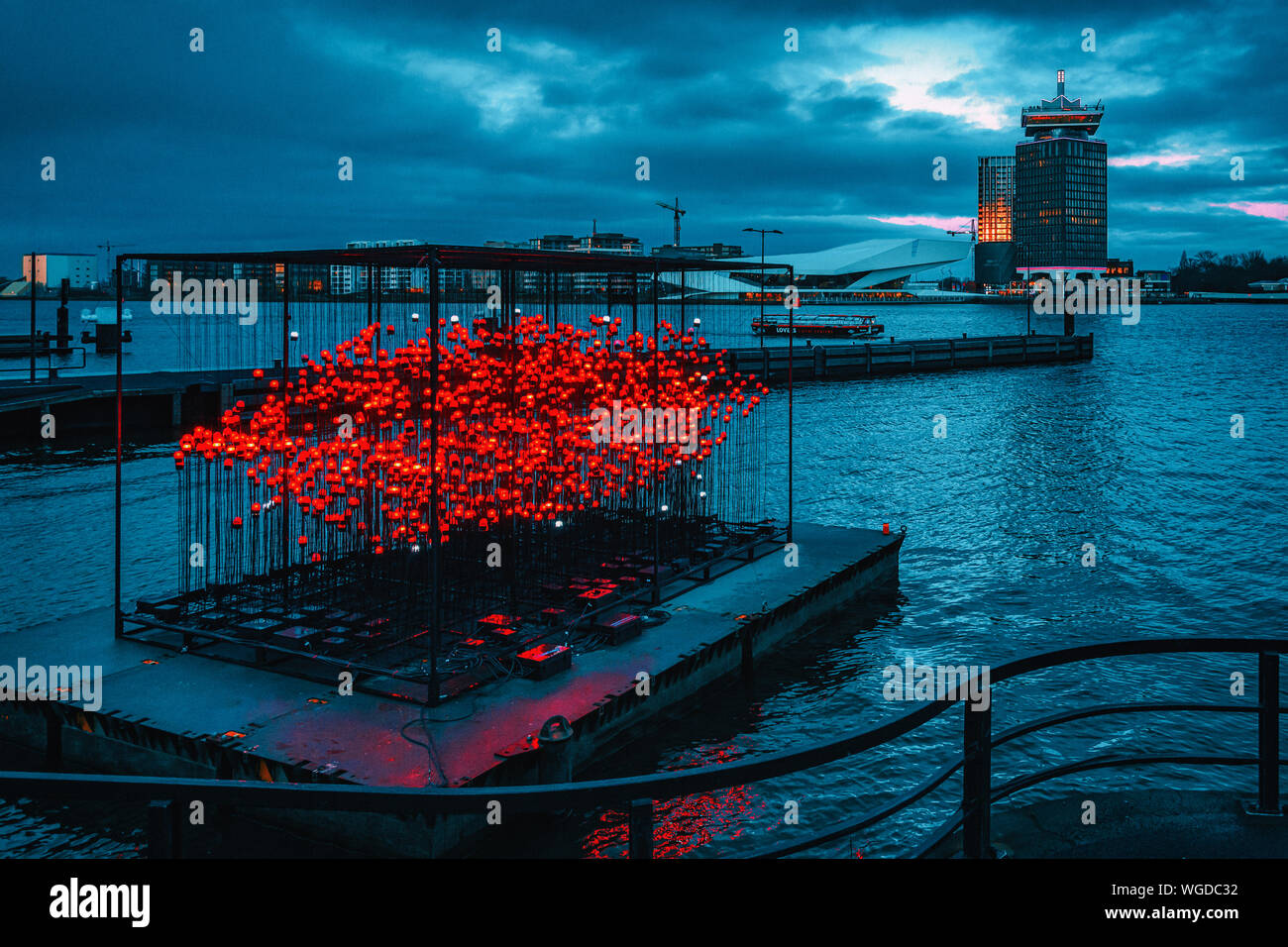 Amsterdam, Netherlands - January 14, 2019: Light Festival Amsterdam, floating red light object on the IJ river in Amsterdam with the Eye Film Museum a Stock Photo