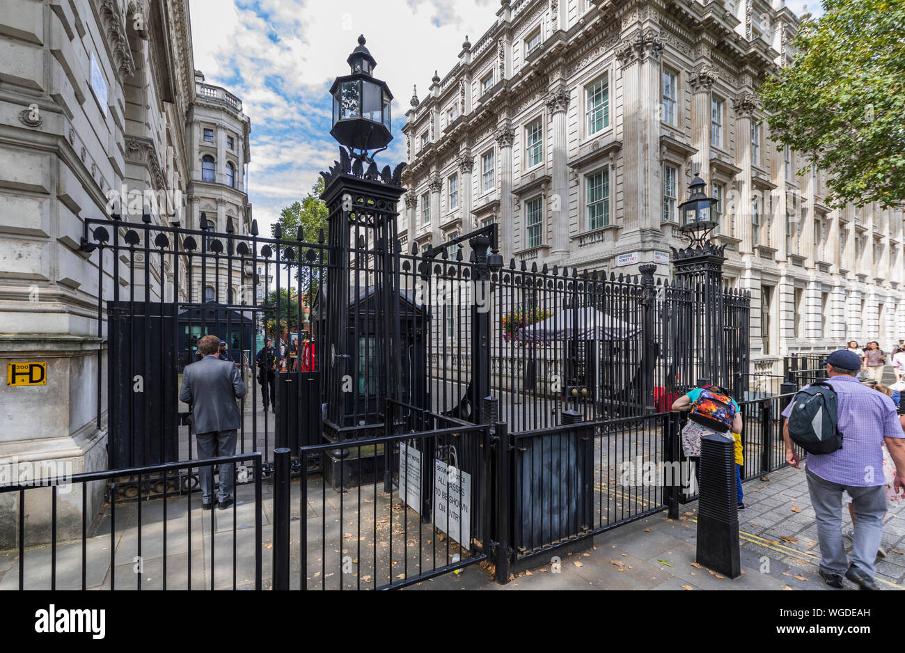 Armed police guarding security gate at the entrance to Downing Street, City of Westminster, London, England, UK. Stock Photo