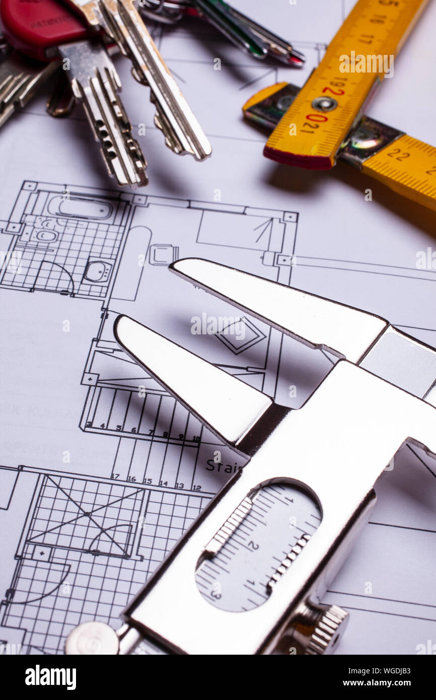 house blueprint, wood measuring stick, gauge and keys - real estate concept Stock Photo
