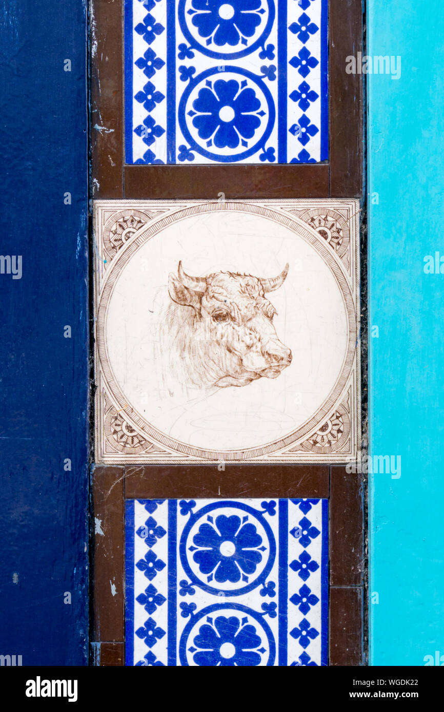 Tiles featuring a bull's head on old Victorian butcher's premises in King's Lynn, Norfolk. Stock Photo