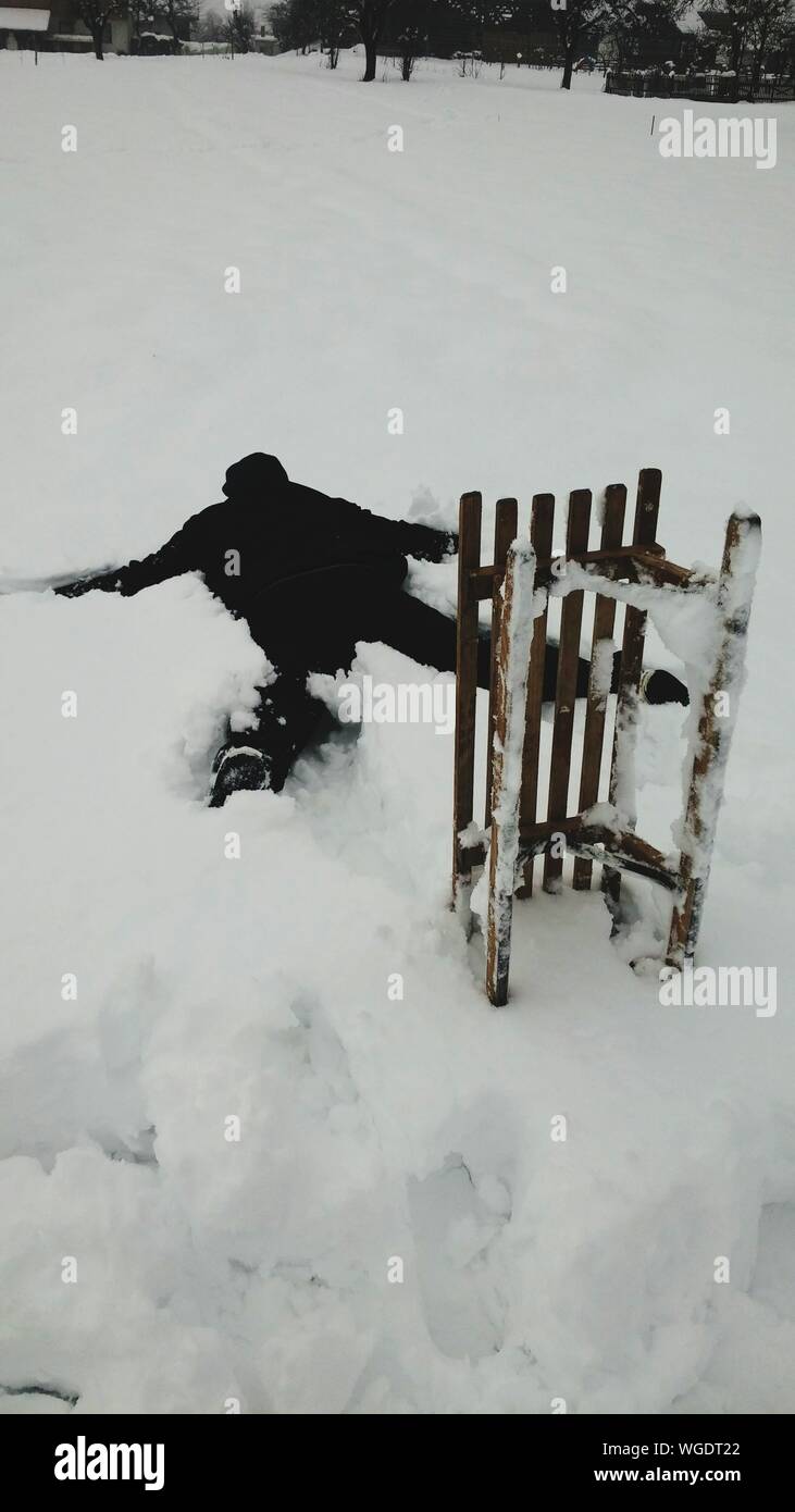 Person Lying On Front In Snow Stock Photo