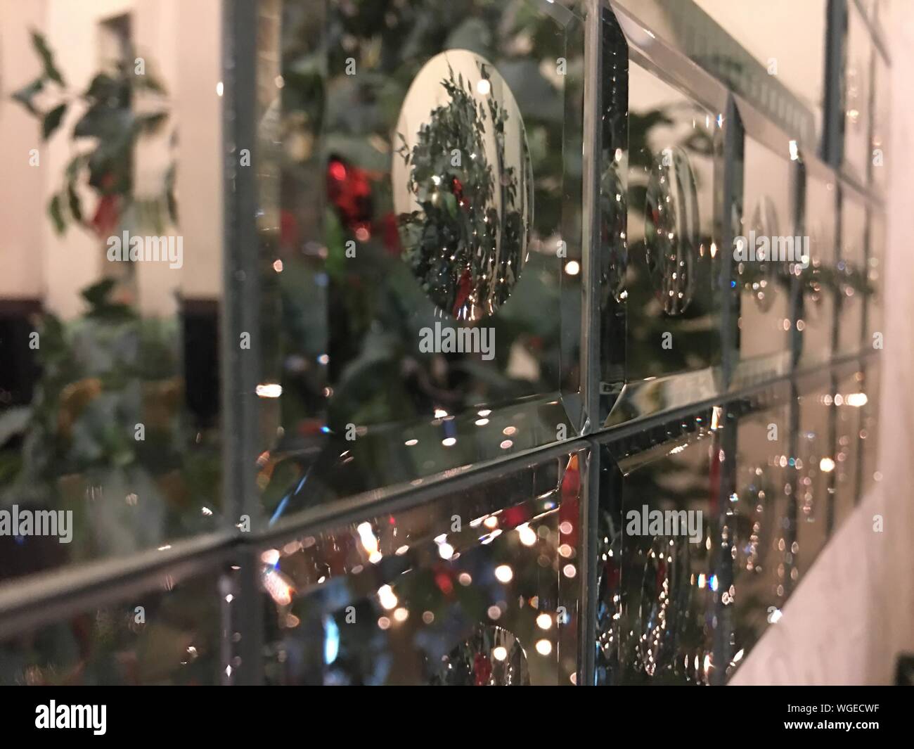 Reflection Of Christmas Decorations On Glass Cabinet Stock Photo