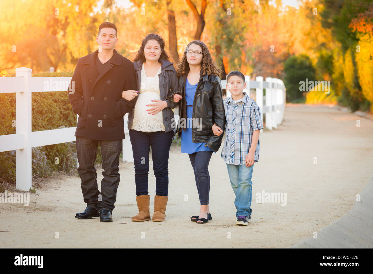 Hispanic Pregnant Family Walking On Path Stock Photo - Alamy