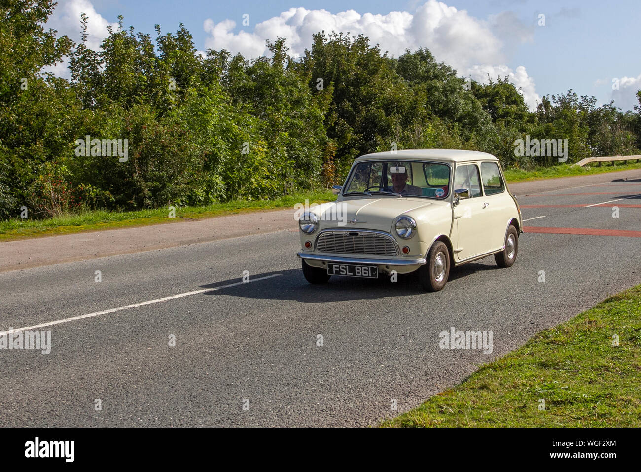 1962 60s white Morris mini at the 2019 Bradford to Morecambe Charity vintage car rally, old, 60s retro vehicle, historic automobile, transportation, classic antique, collection, auto transport, design, motor, drive, historical, history, show, engine, restored collectible, style, historic vehicle run. Stock Photo