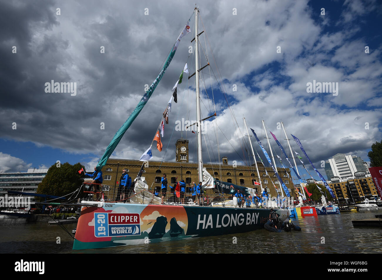 The Ha Long Bay Viet Nam team, one of 11 taking part in the Clipper Round the World Race, waves to crowds at the Departure Ceremony at St Katharine Docks Marina by the river Thames in central London, before their departure down the river. Stock Photo