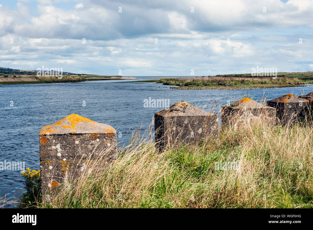 Second World War concrete sea defences on the mouth of the river North Esk, Angus, Scotland, UK with view out to sea. Stock Photo