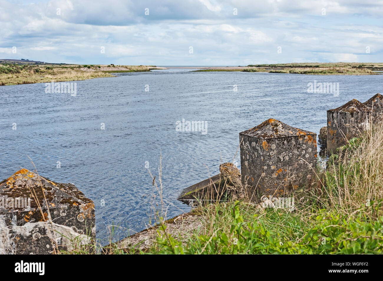 Second World War concrete sea defences on the mouth of the river North Esk, Angus, Scotland, UK with view out to sea. Stock Photo