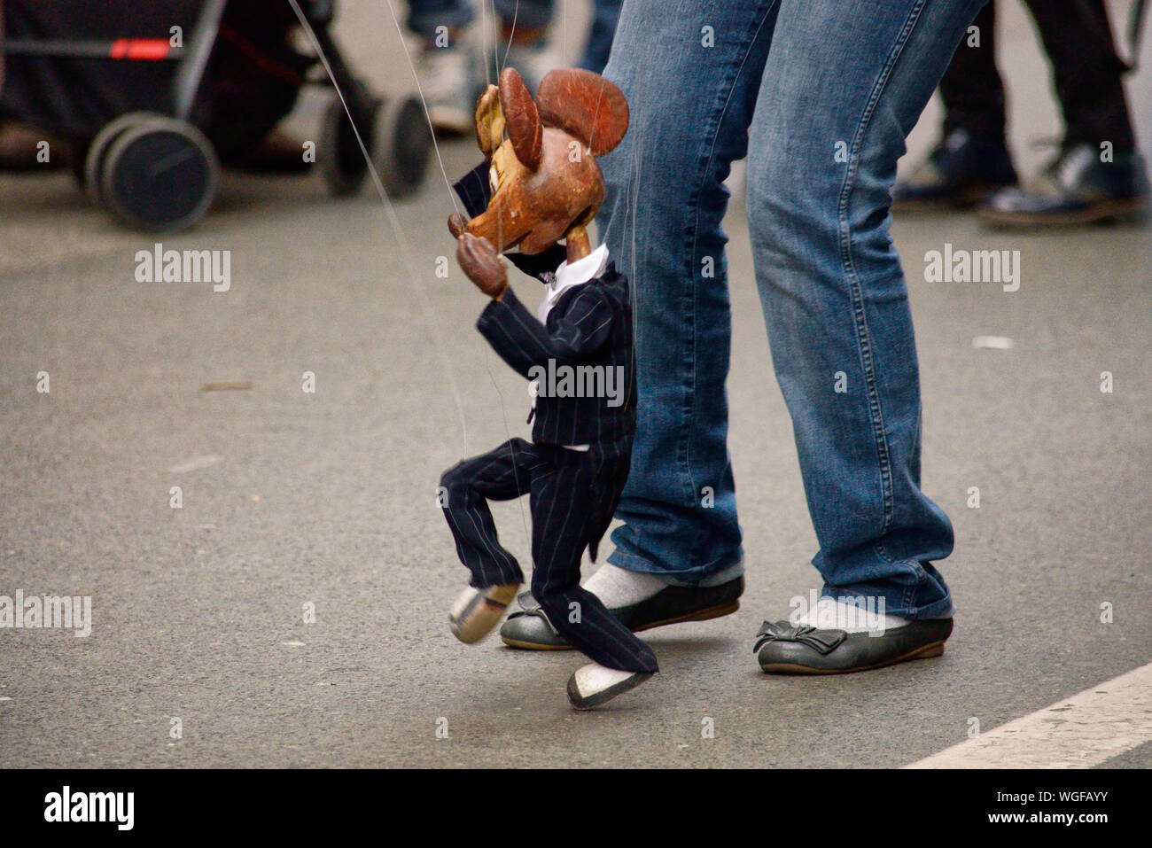 Low Section Of Person And Puppet In Street Performance Stock Photo