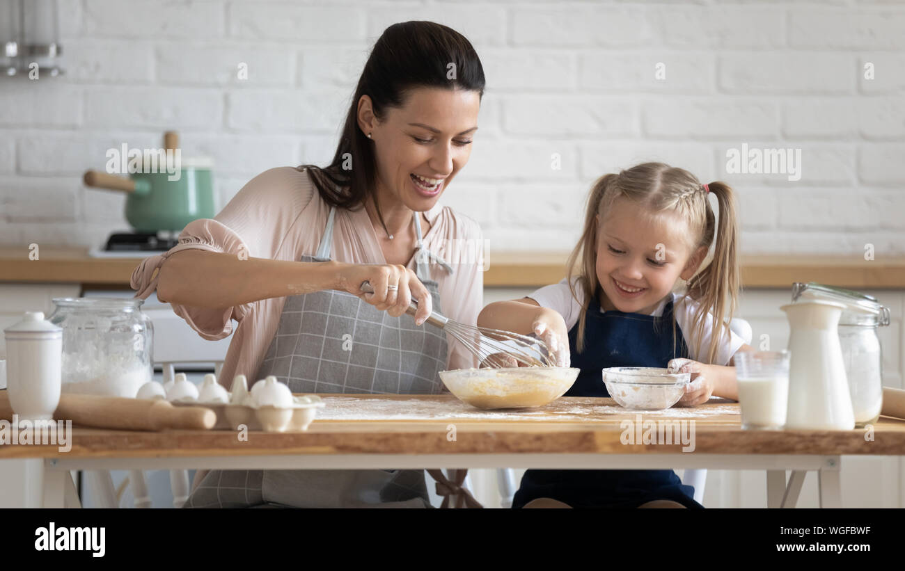Woman and daughter cook pie together at home Stock Photo Alamy