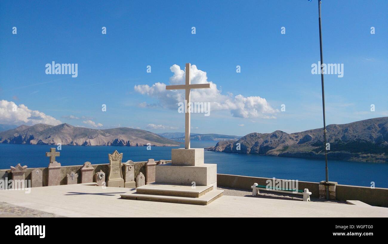 Religious Cross Against Blue Sky Stock Photo