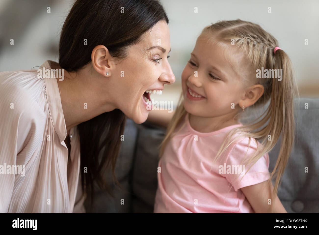 Woman and daughter having fun playing at home Stock Photo