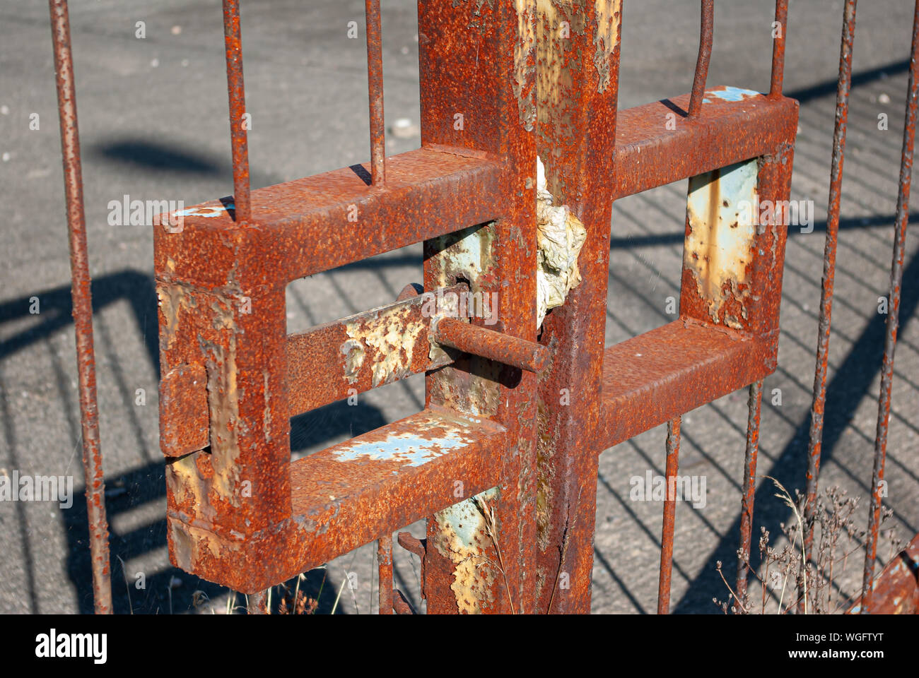 Close-up of rusty metal gate latch on a set of industrial gates Stock Photo