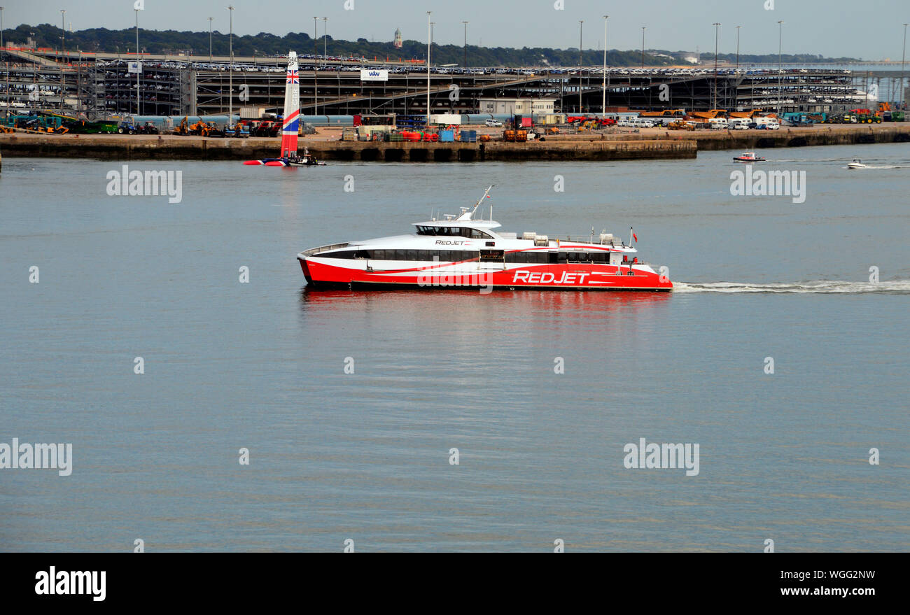 The Red Jet 6 Hi-Speed Catamaran Passenger Ferry owned by the Red Funnel Ferry Company in the Solent heading for Southampton Harbour, Hampshire. Stock Photo