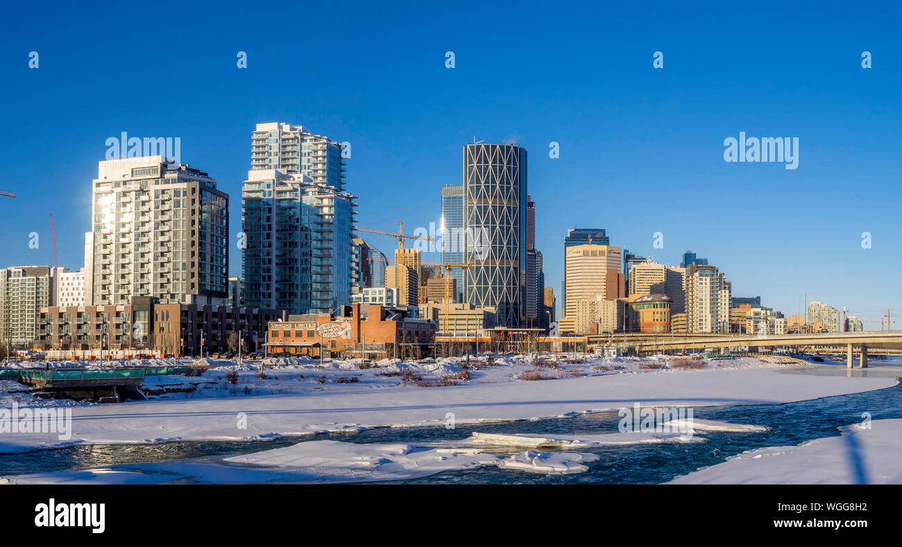 Calgary downtown as viewed from the East Village along the Bow River on ...