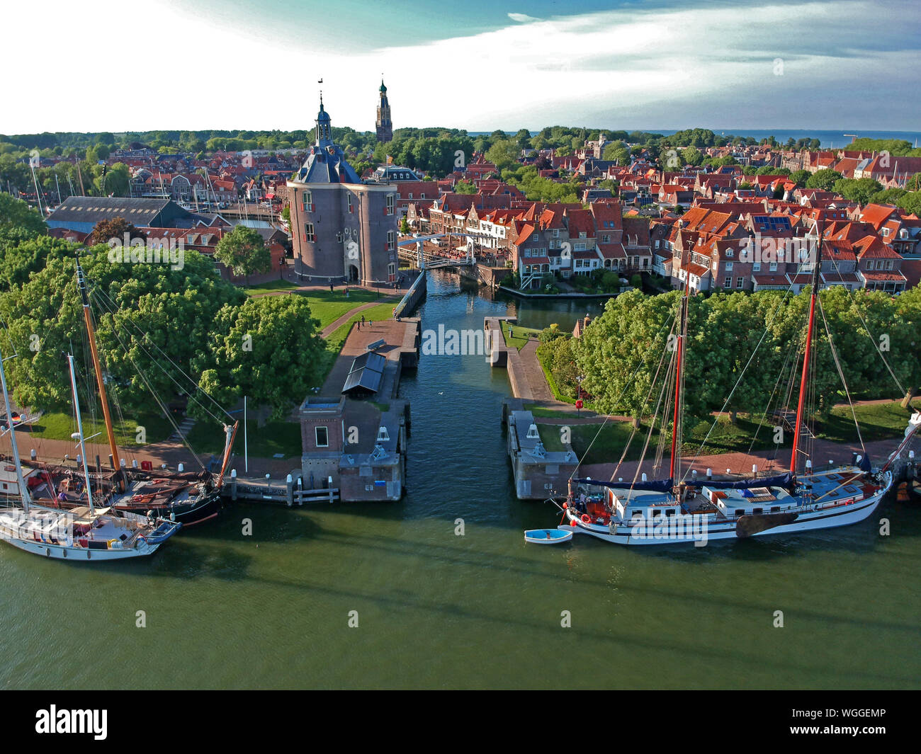 drone photo of the harbor of enkhuizen with sailing boats a lock and tower the drommedaris and an old white drawbridge. Photo taken with a dji spark d Stock Photo