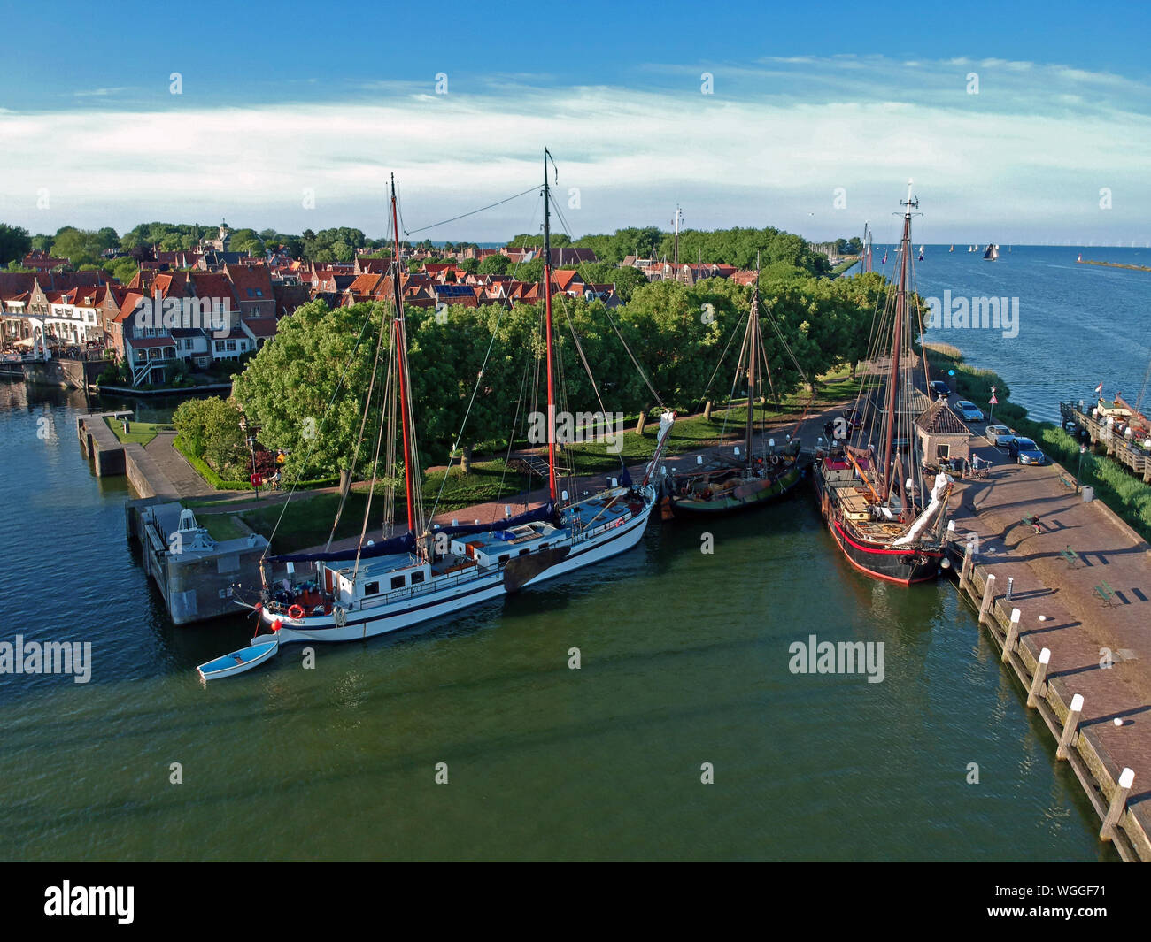 Drone photo of the harbor of enkhuizen with sailing boats a lock and tower the drommedaris and an old white drawbridge. Photo taken with a dji spark Stock Photo