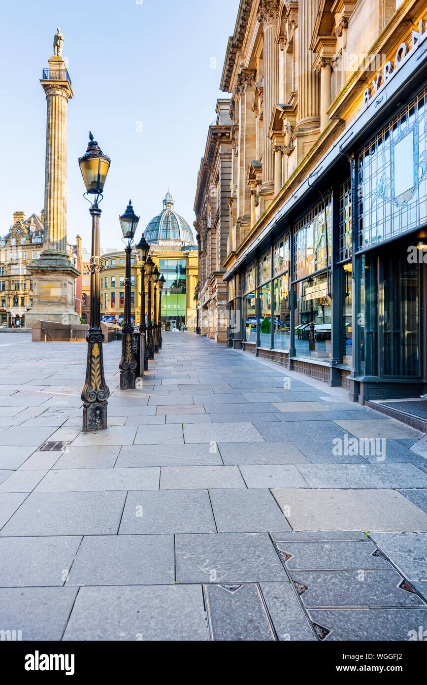 Line of lamp posts leading towards Grey's Monument and the dome of Monument Mall at the top of Grey Street in Newcastle upon Tyne Stock Photo