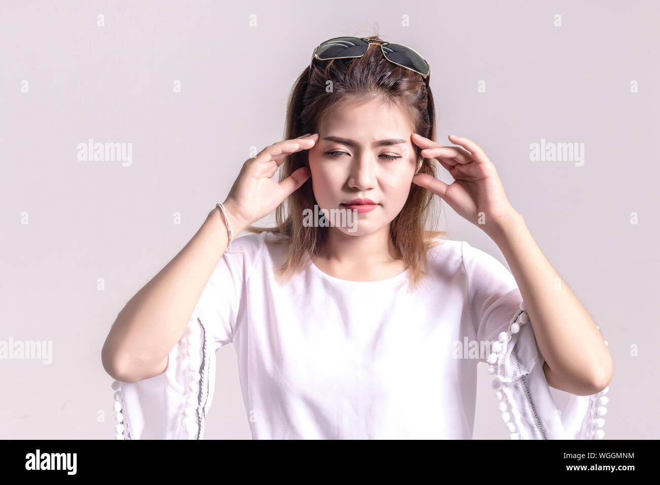 Stressed Young Woman Standing Against White Background Stock Photo