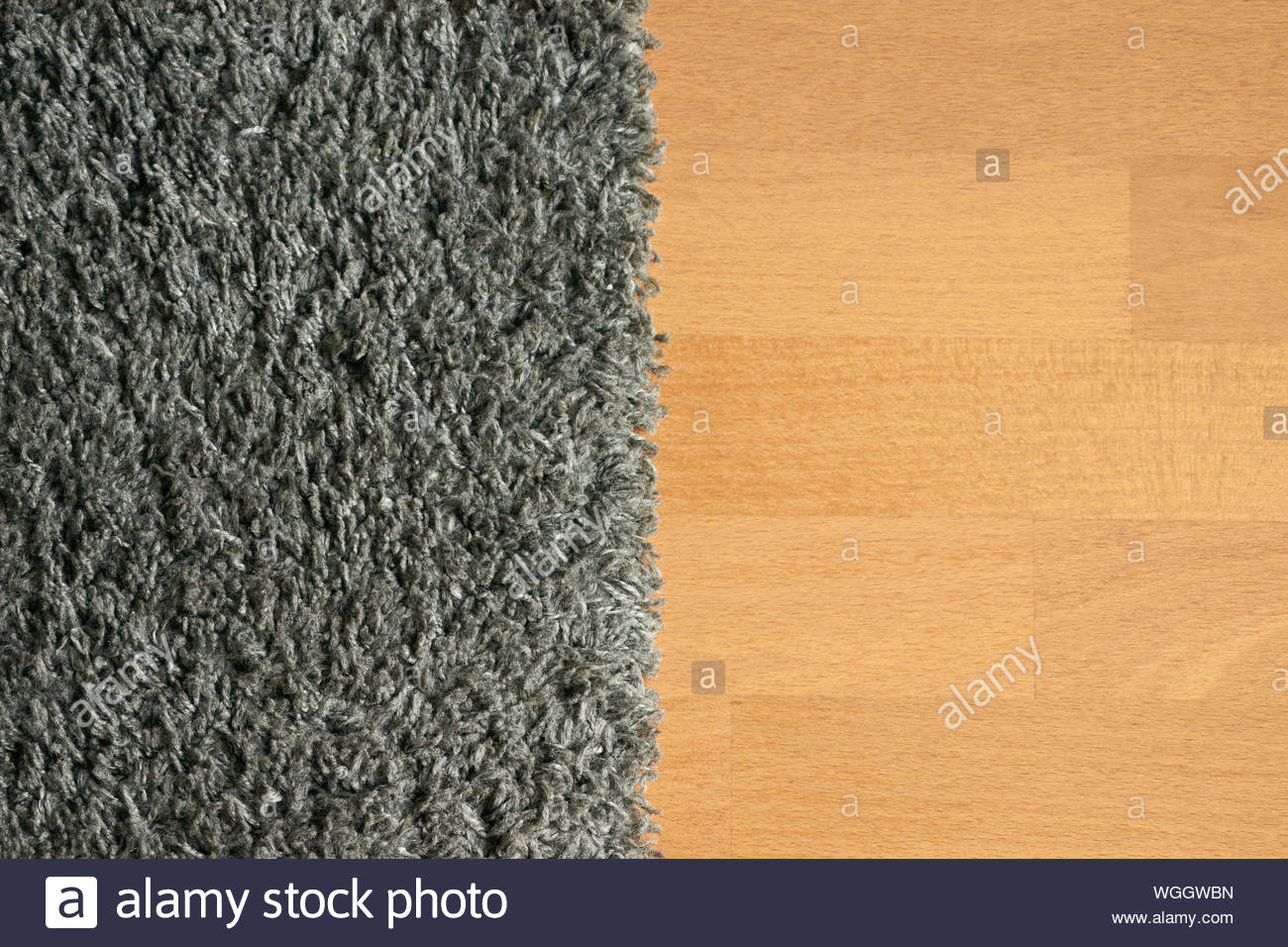 Combination Of Dark Gray Carpet And Light Brown Wooden Floor Stock
