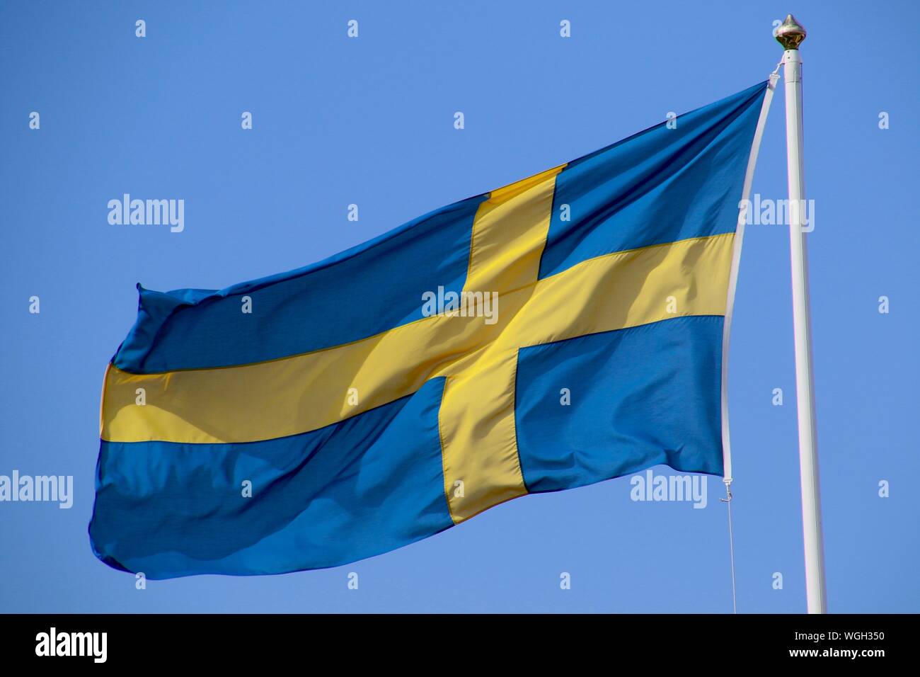 Swedish Flag Against Blue Sky Stock Photo Alamy