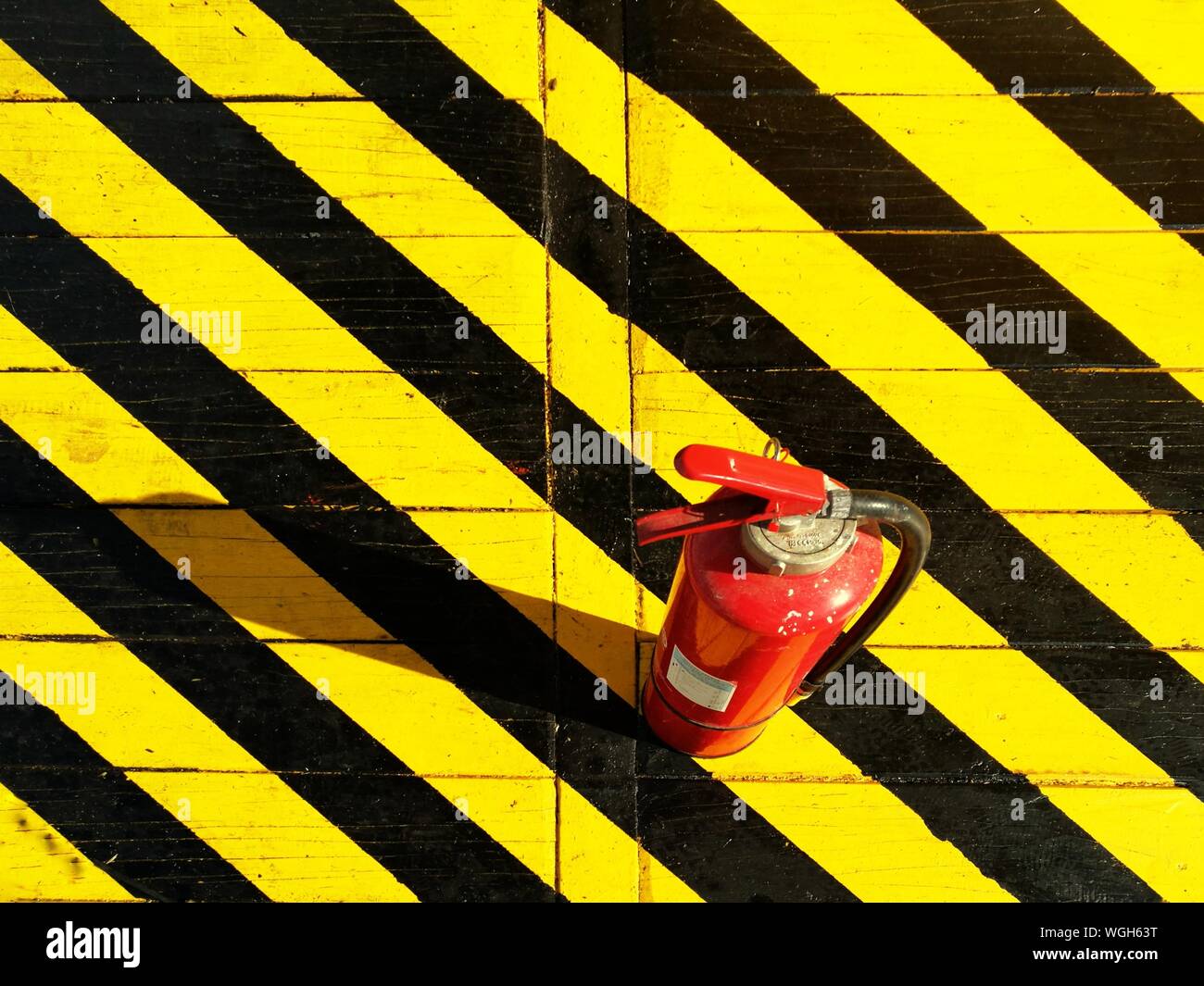 Download High Angle View Of Fire Extinguisher On Yellow And Black Striped Floor Stock Photo Alamy PSD Mockup Templates