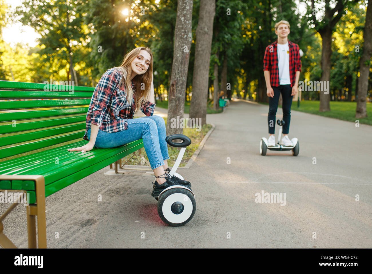 Couple leisures with gyro board in summer park Stock Photo