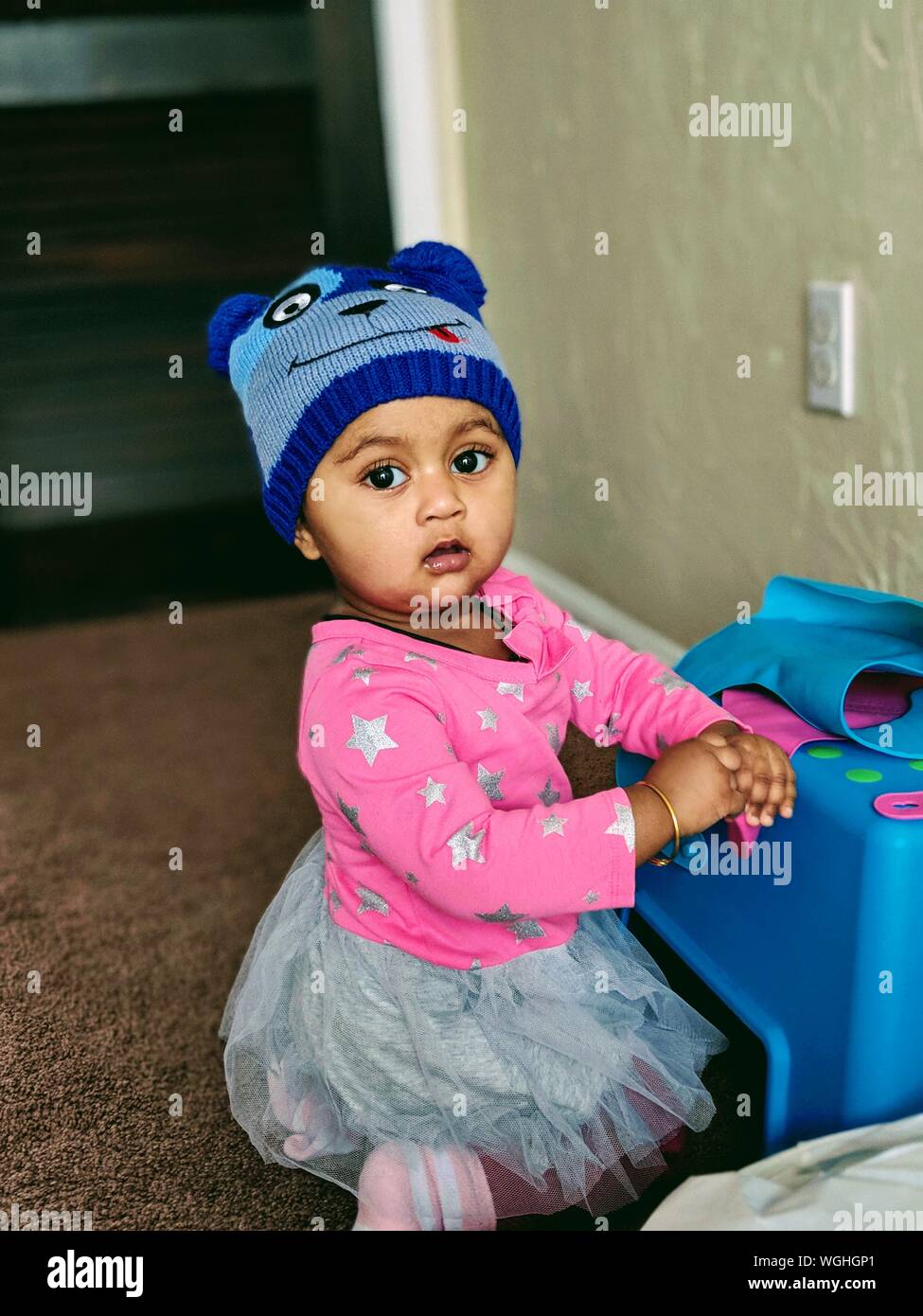 Portrait Of Baby Girl Kneeling At Home Stock Photo Alamy
