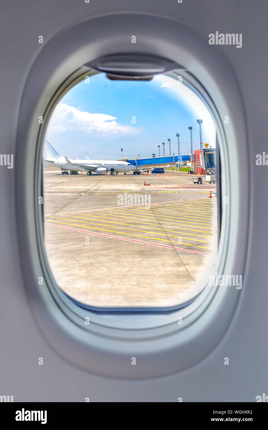 The view from the window of the porthole of an airplane at the airport. Stock Photo