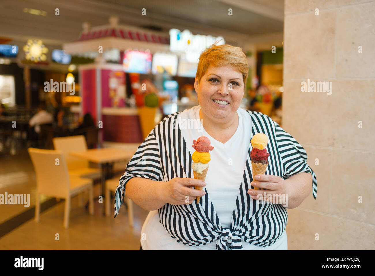 Woman eating ice cream fat hires stock photography and images Alamy