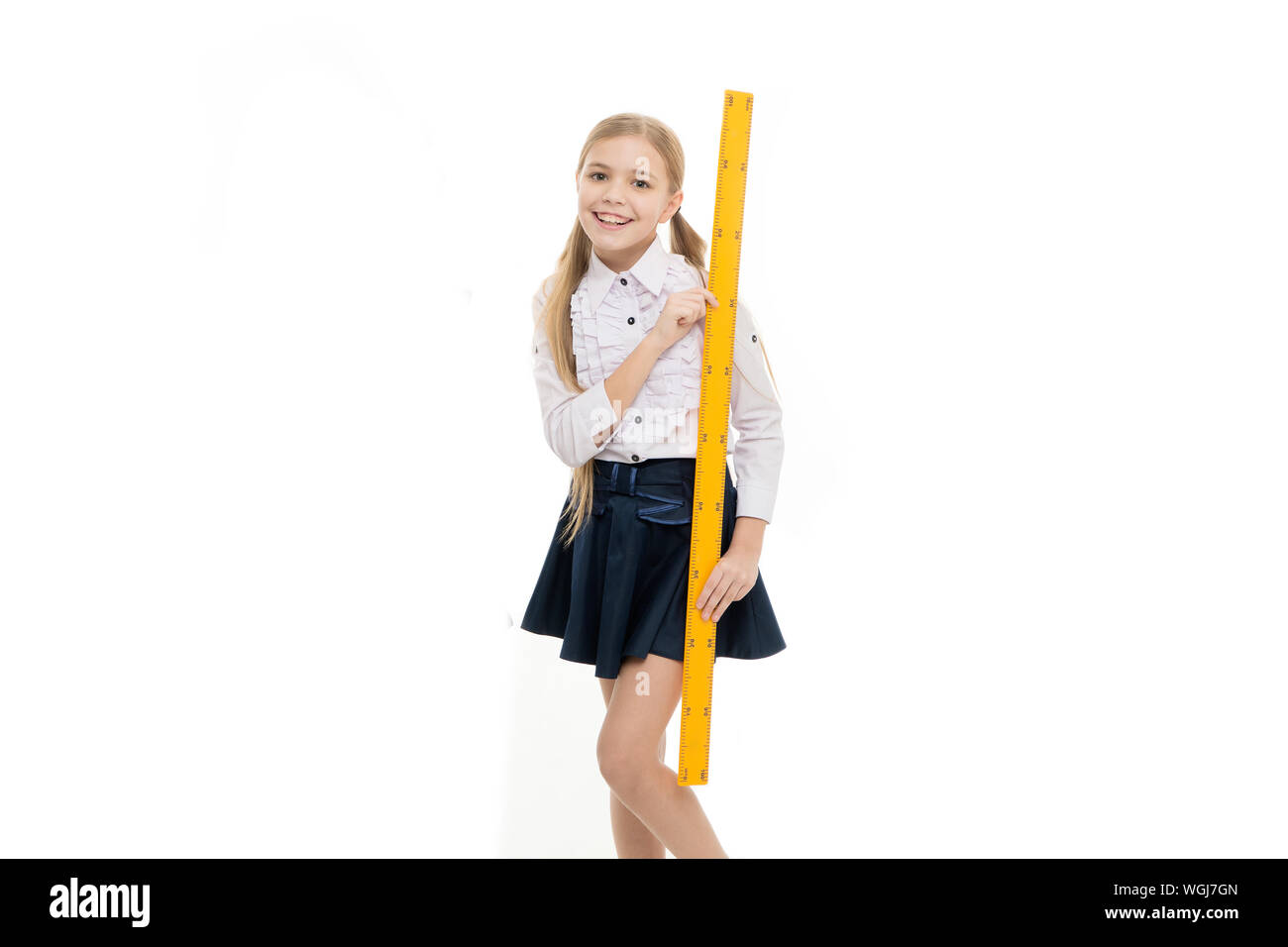 What a long ruler. Surprised little student holding rigid wooden ruler on  yellow background. Small child taking measurements with metric ruler. My  ruler is one meter long Stock Photo - Alamy