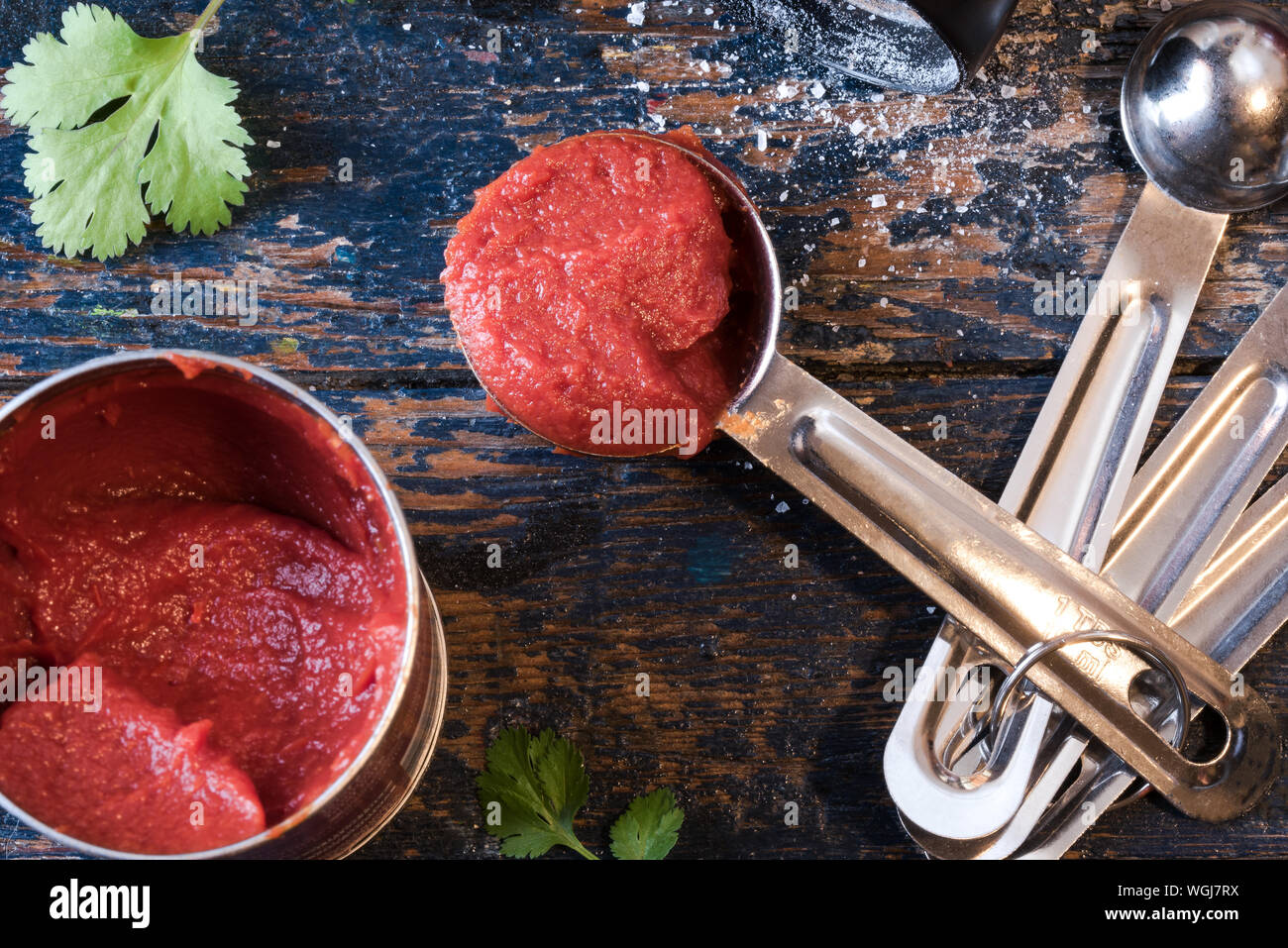 Directly Above Shot Of Tomato Paste In Container And Spoon On Wooden Table Stock Photo
