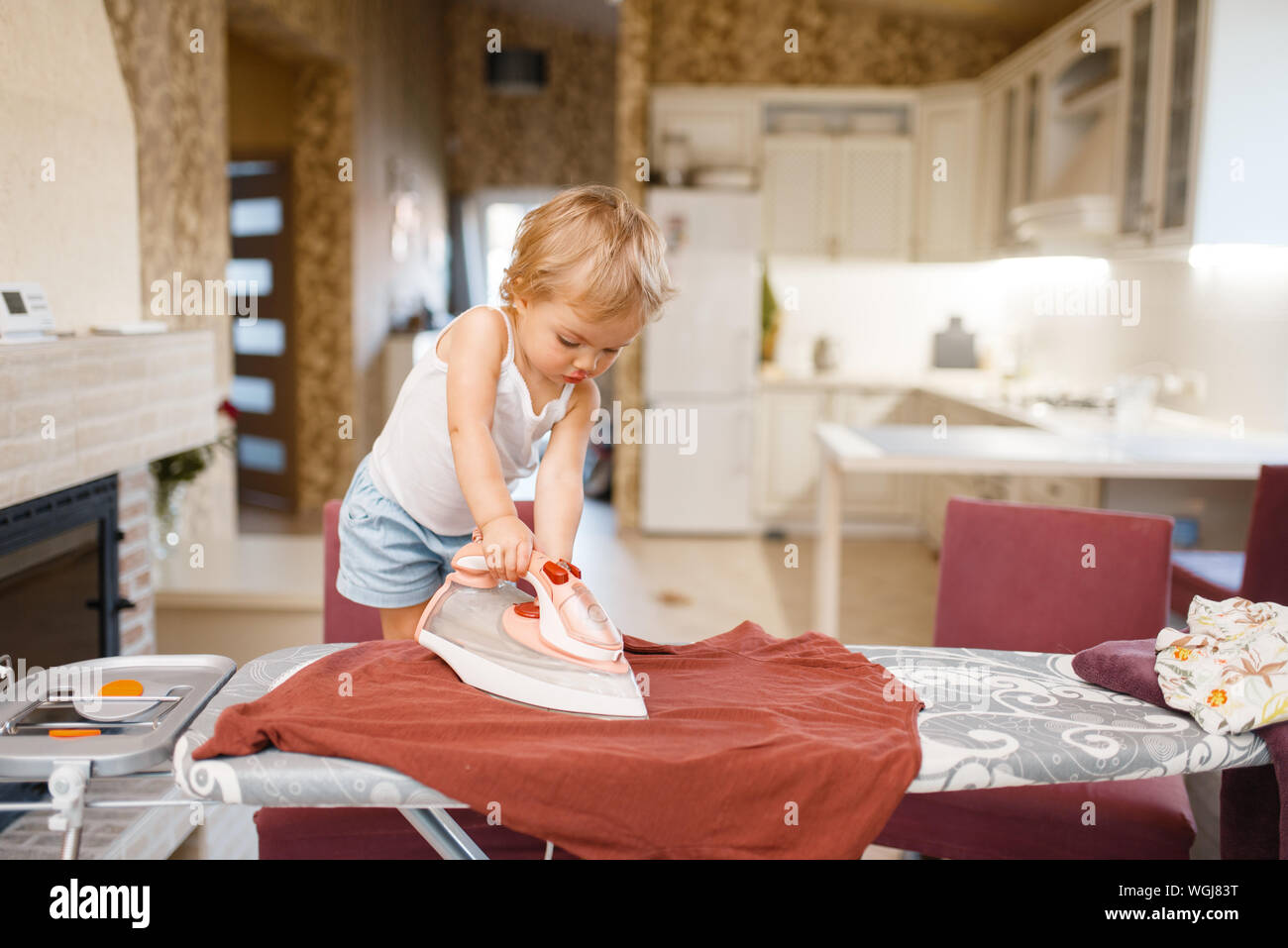Little baby irons clothes on the kitchen Stock Photo Alamy