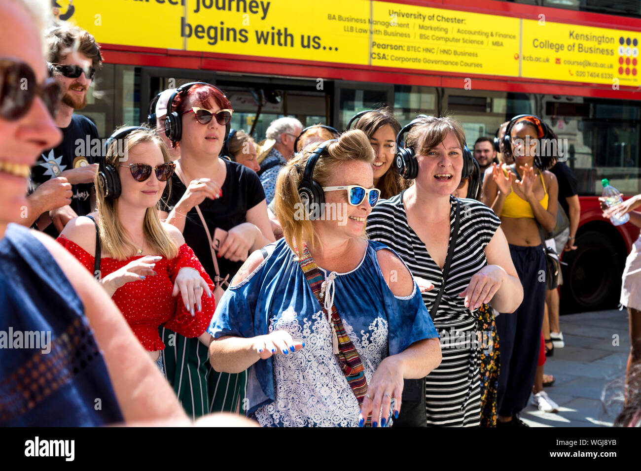 Group of people participating in a Silent Disco Tour in London, UK Stock Photo