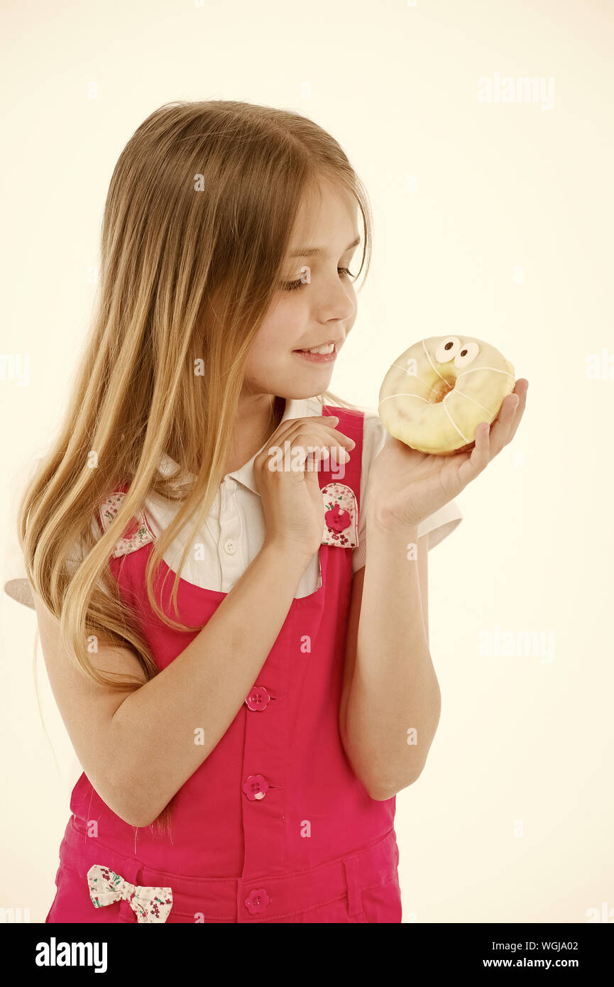 How bad are sweets for your kids. Girl cute smiling face holds sweet