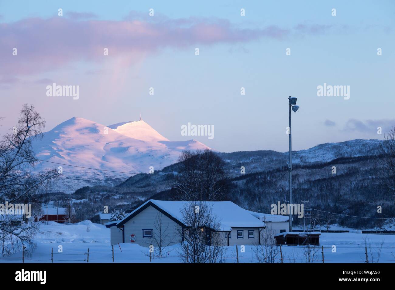traditional norwegian wooden house and mountains in the distance