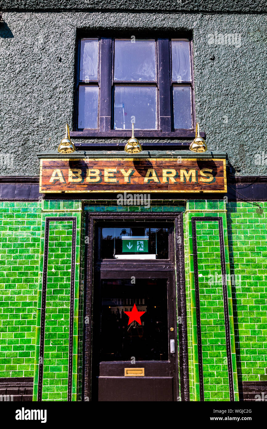English pub facade with green ceramic tiles, Abbey Arms in Abbey Wood Village, UK Stock Photo