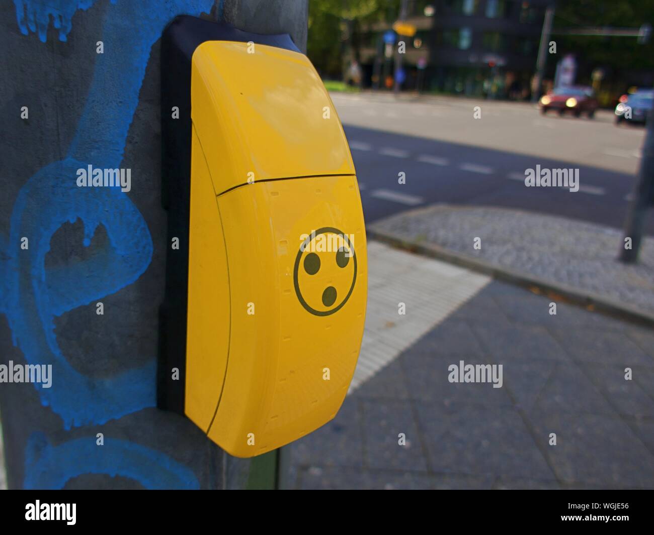 Close-up Of Yellow Sign By Sidewalk Stock Photo