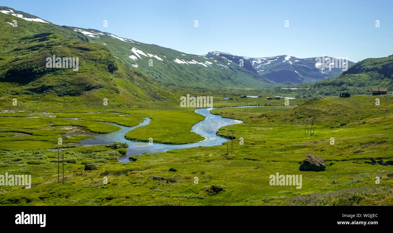 river run on green meadow, mountains, forest, snow peaks, sky, Myrdal, Sogn og Fjordane, Norway, Scandinavia, Europe, NOR, travel, tourism, destinatio Stock Photo