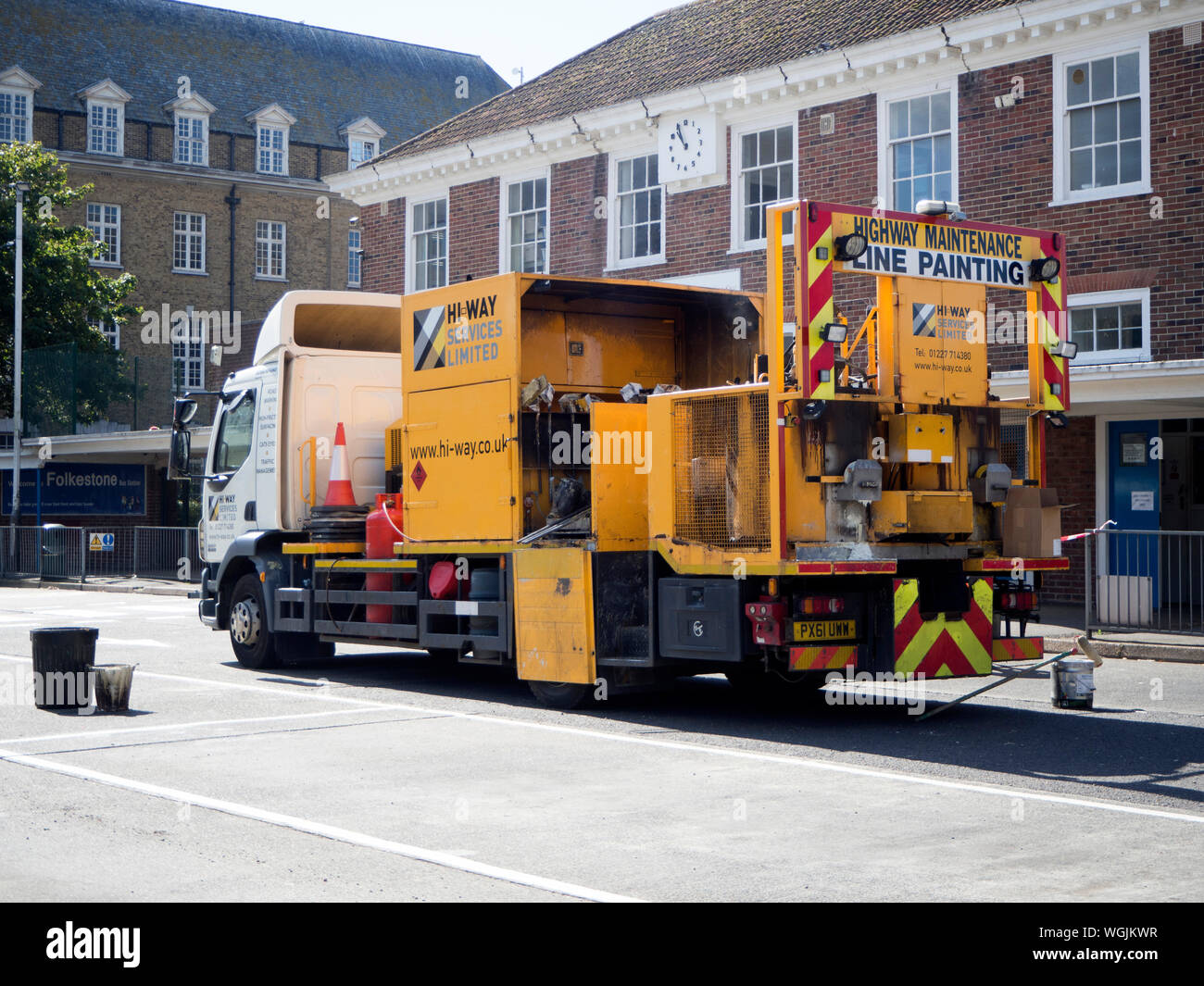 Yellow line painting lorry working in bus depot Stock Photo