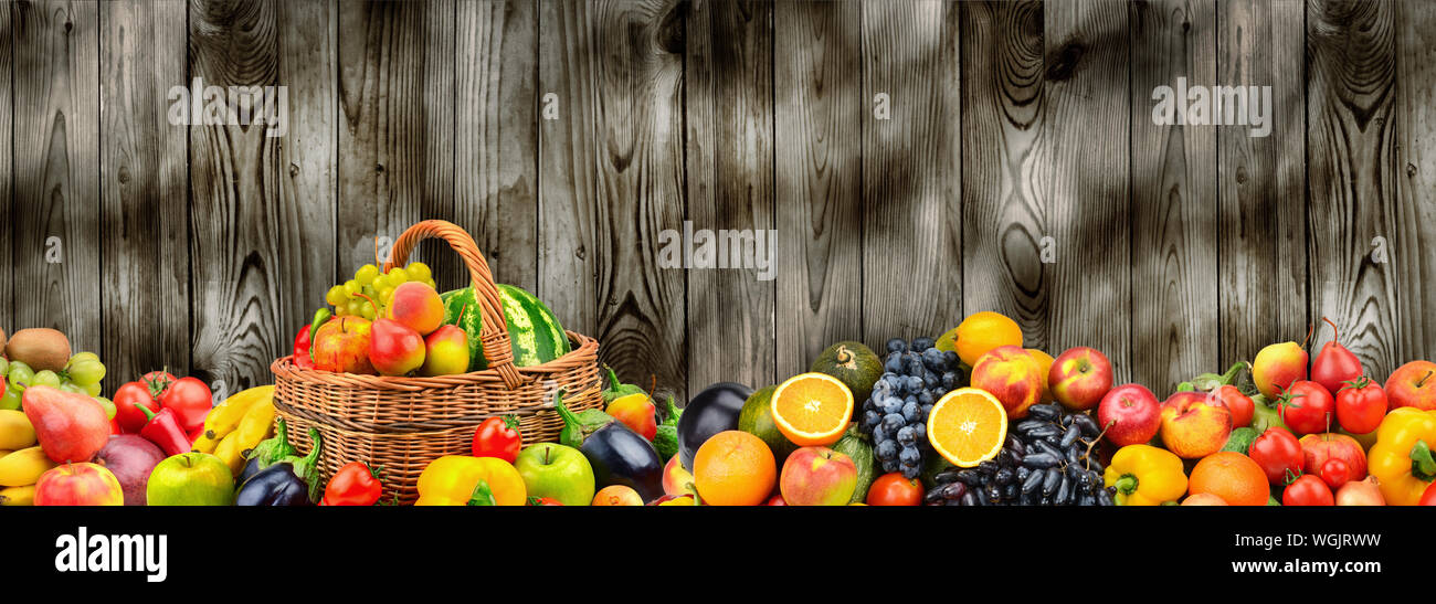Panoramic photo healthy vegetables and fruits on background wooden wall. Free space for text. Stock Photo