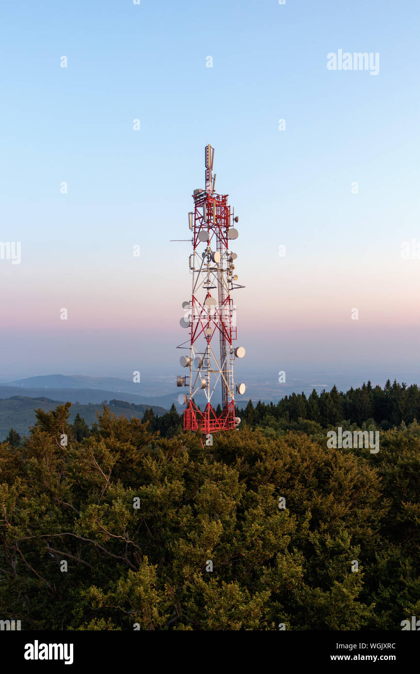 Communication tower high above the forest Stock Photo