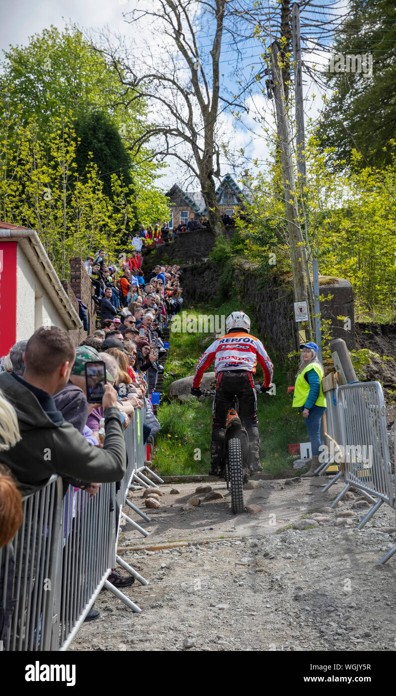 Scottish Six Days Trial (SSDT) motorcyle rider goes up a rocky and steep part of the course in Fort William in the Scottish highlands Stock Photo