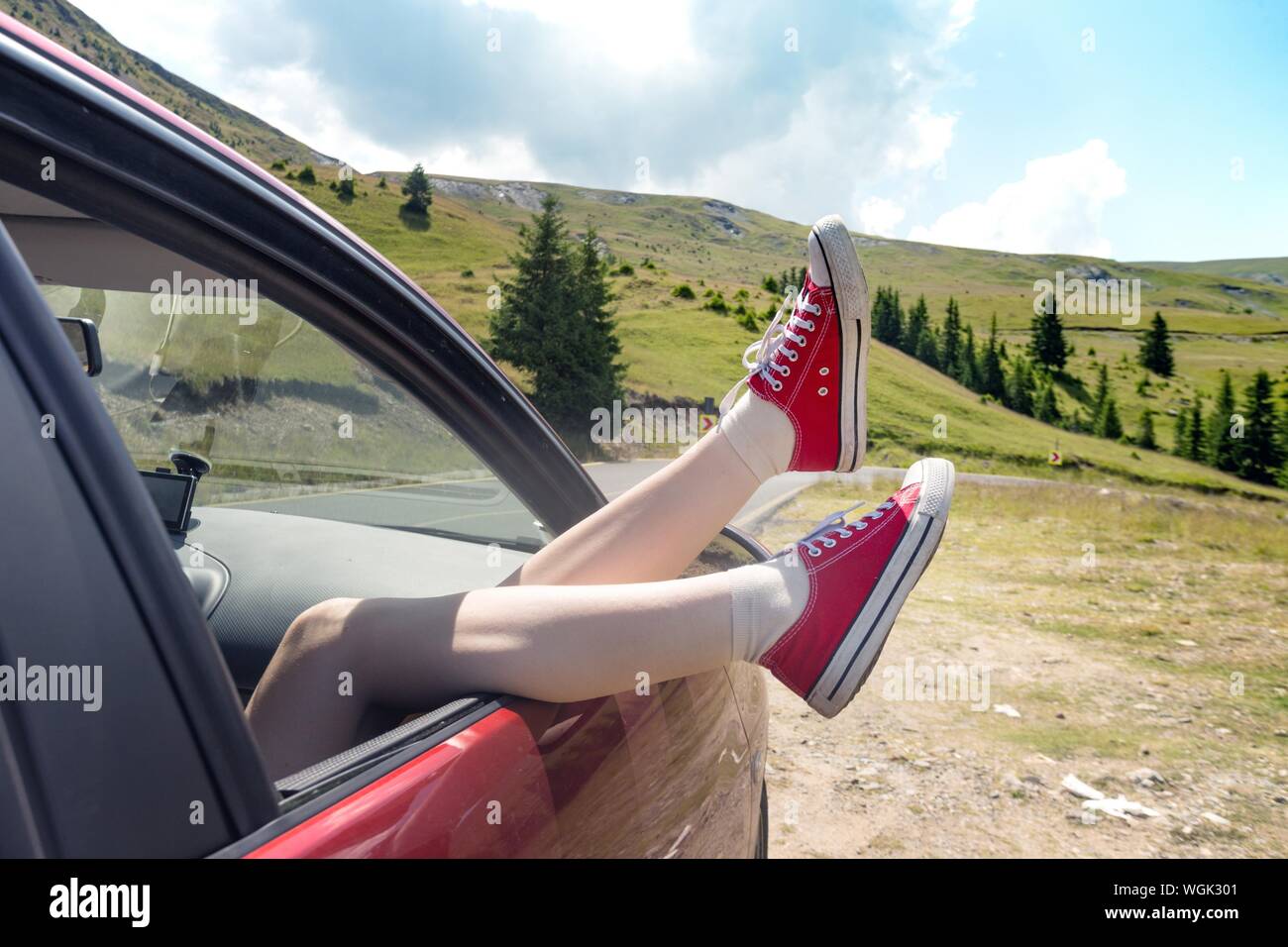 Girl legs in bright sneakers sticking out of the car Stock Photo Alamy
