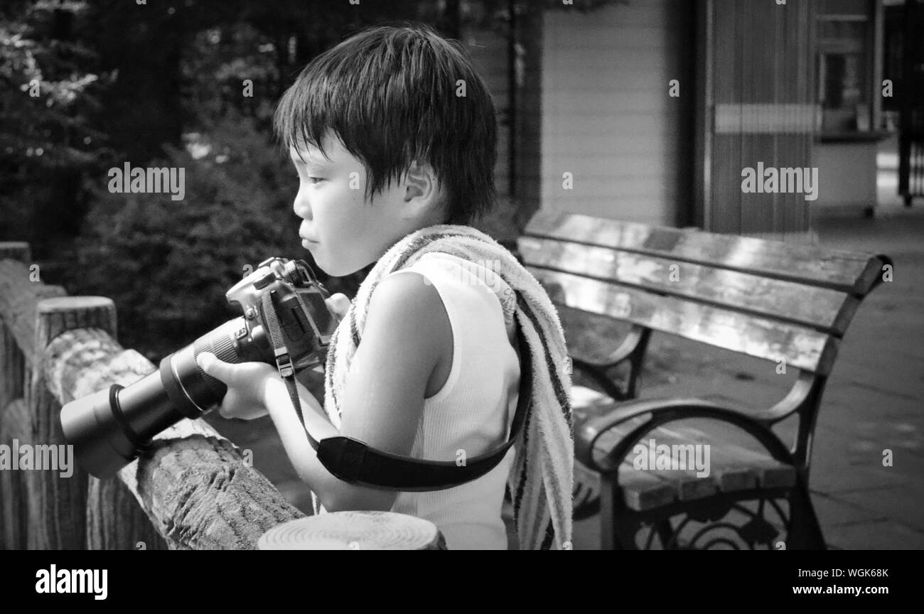Boy standing looking at camera hi-res stock photography and images - Alamy