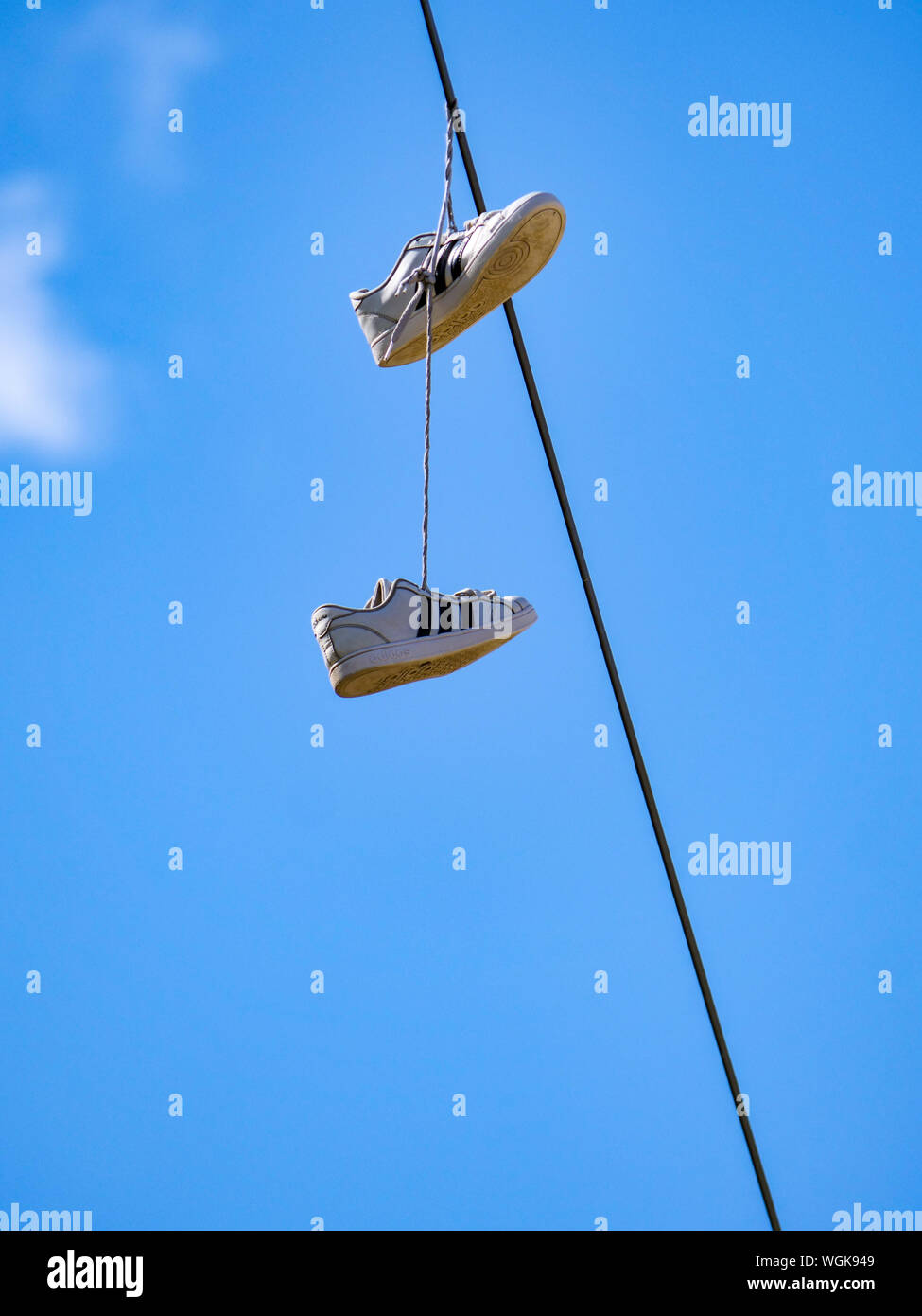 Sneakers hanging from utility wire Stock Photo Alamy