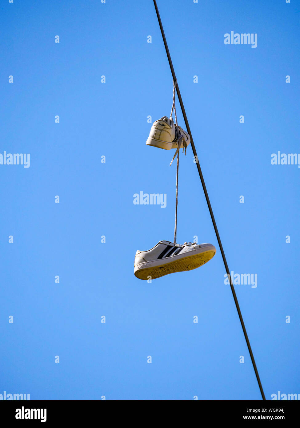 Shoes hanging from telephone line hires stock photography and images