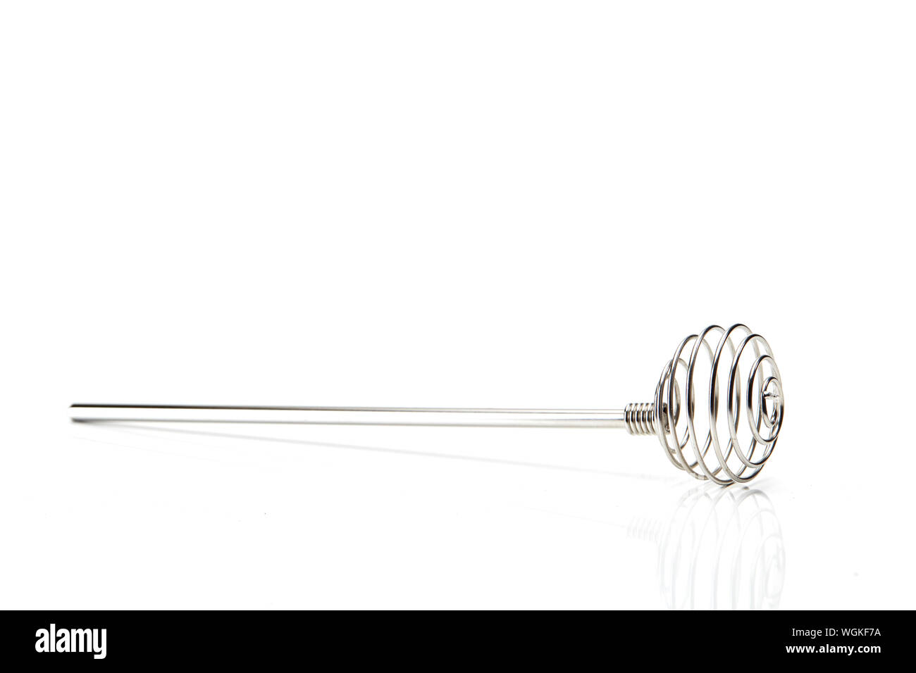 Close-up Of Wire Whisk Over White Background Stock Photo