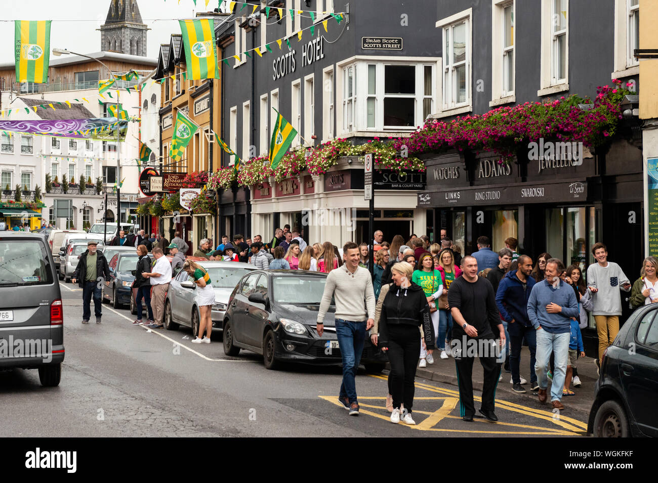 Killarney match day and crowd of people GAA football supporters in College Street Killarney, County Kerry, Ireland Stock Photo