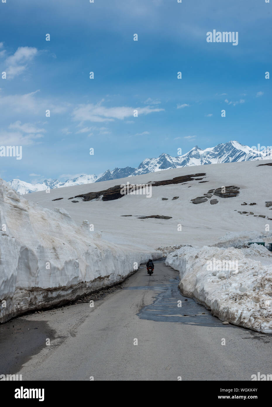 Empty Road at Snow Covered Rohtang pass in June - Stock Photo