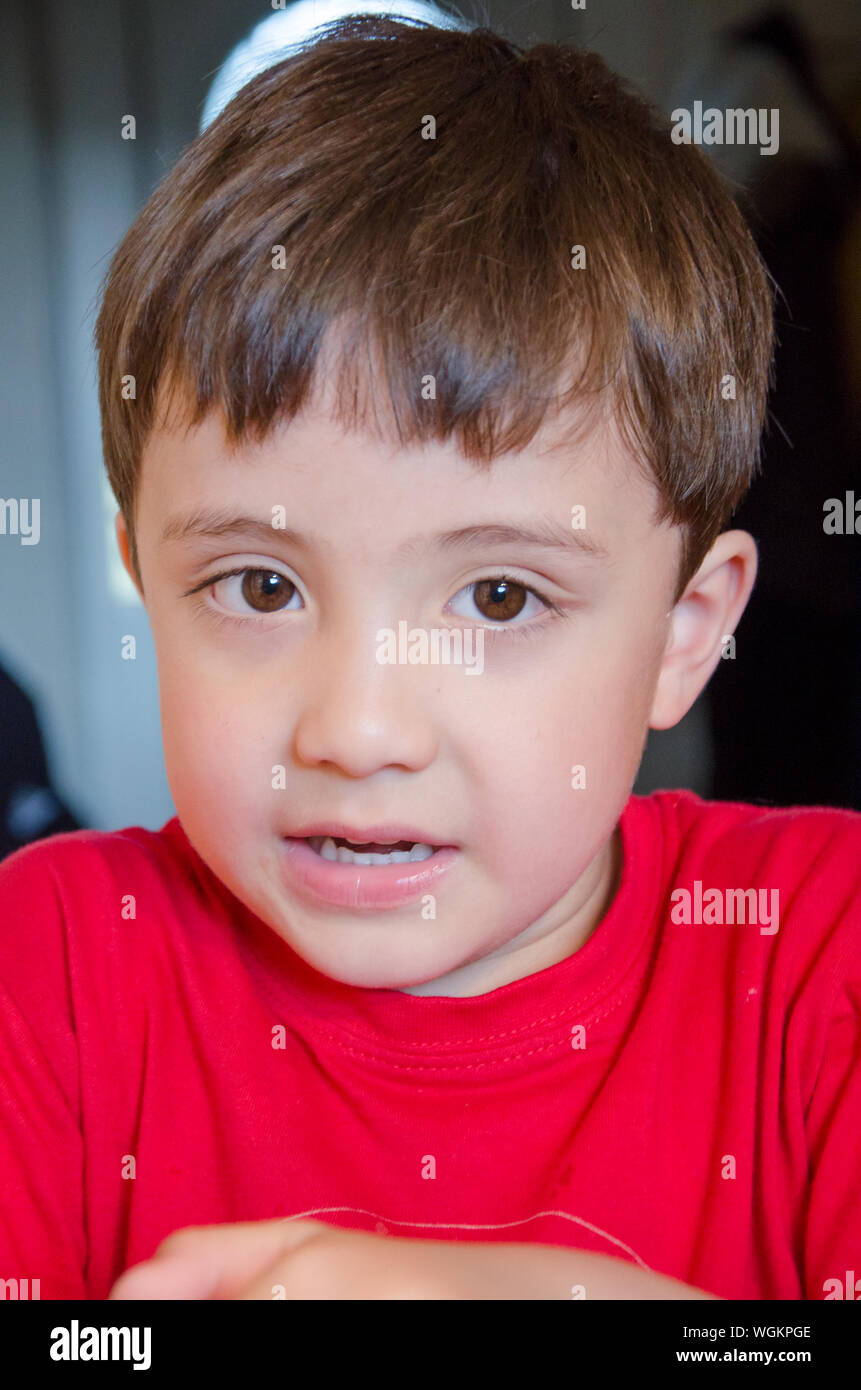 Close-up Portrait Of Boy Wearing Red T-shirt Stock Photo